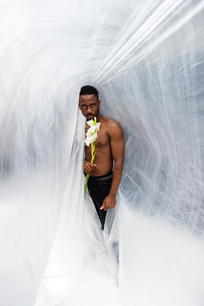 Homme plein coup posant avec une fleur