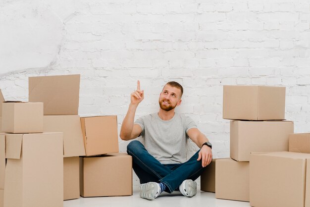 Homme près des boîtes pointant vers le haut