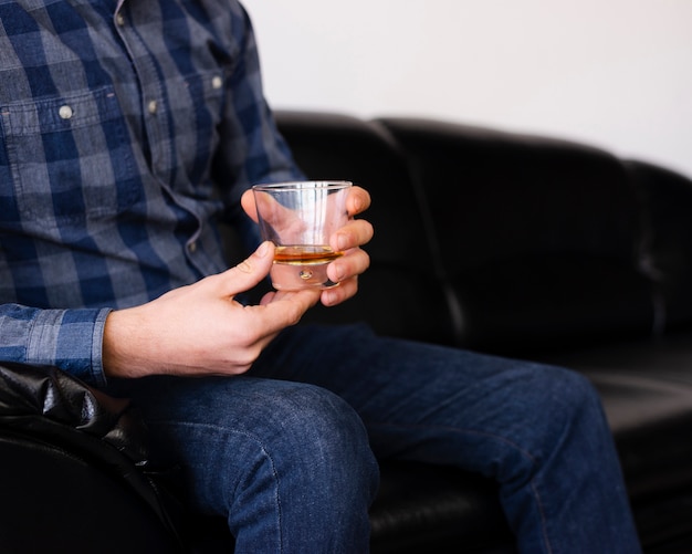 Homme profitant d'un verre au salon de coiffure