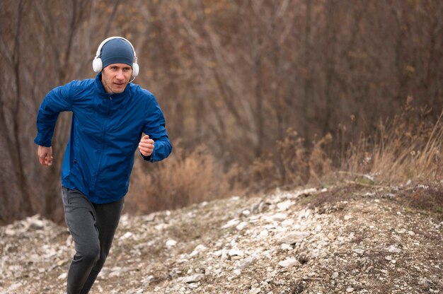 Homme qui court sur un sentier dans la nature