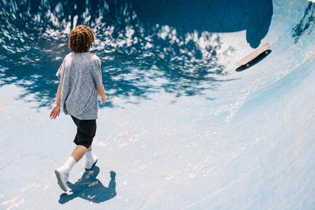 Homme qui marche à skateboard