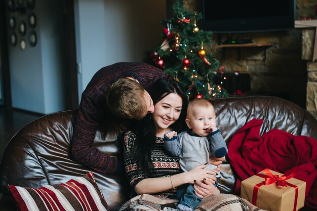 Photo gratuite l'homme regardant sa femme alors qu'elle tient son bébé dans ses bras