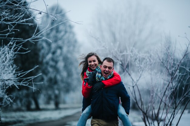 L&#39;homme en robe d&#39;hiver avec sa petite amie dans le dos