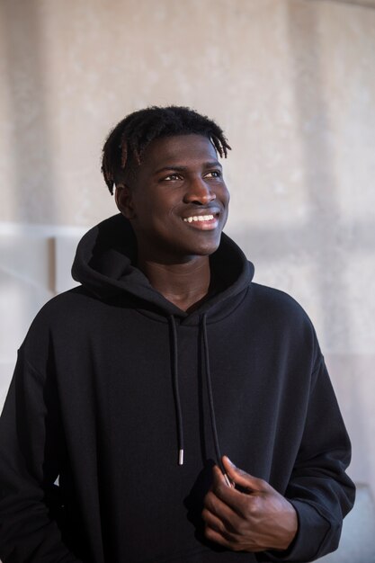 Homme souriant à coup moyen portant un sweat à capuche