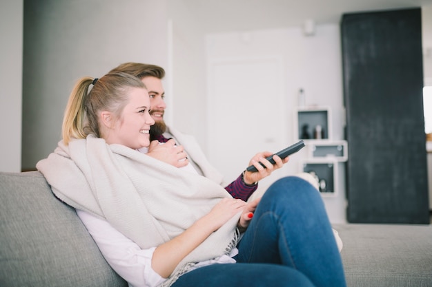 Photo gratuite homme souriant et femme regardant la télévision