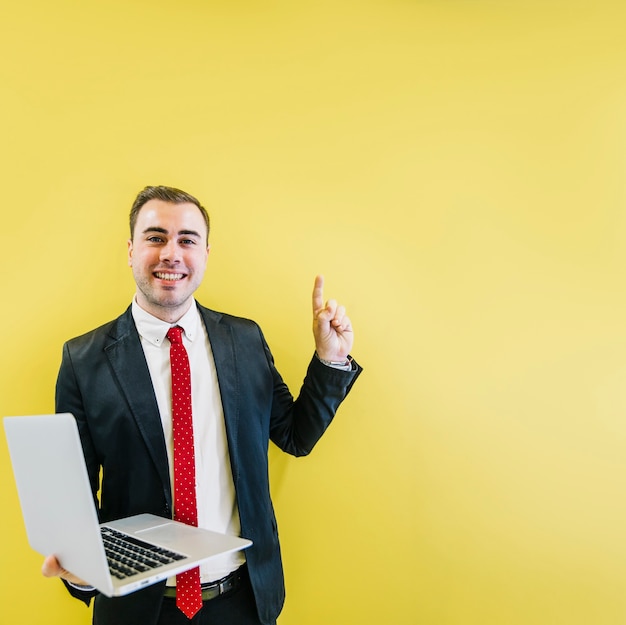 Photo gratuite homme souriant avec solution sur jaune