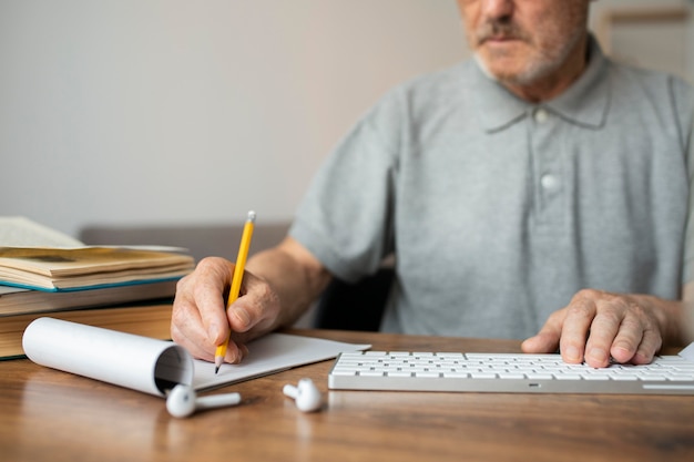 Homme supérieur prenant des notes en classe