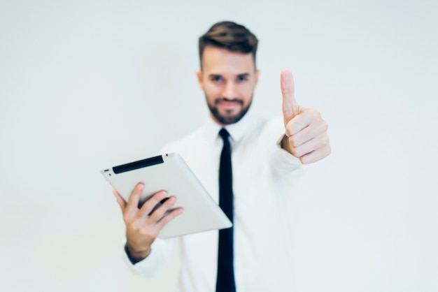 Homme avec une tablette et pouces vers le haut