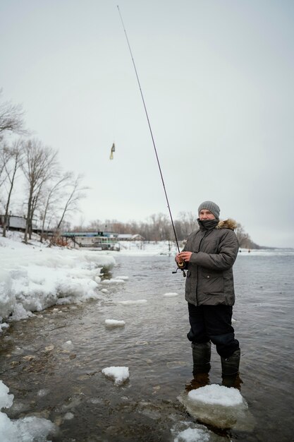 Homme tenant une canne à pêche