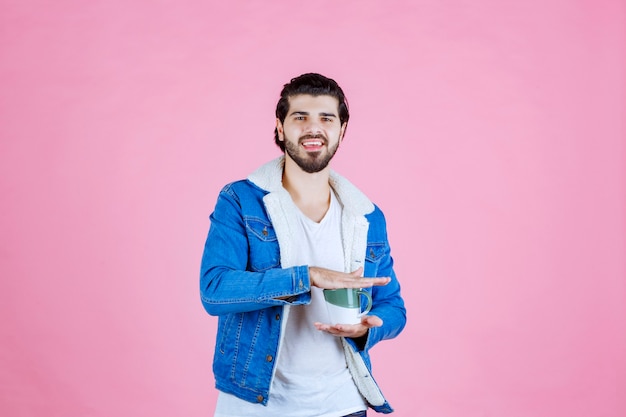 Homme tenant la tasse de café entre deux mains