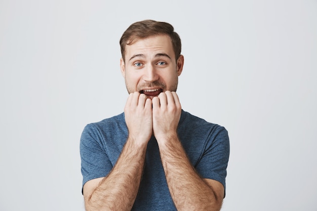 Photo gratuite homme tentant d'essayer le produit, se rongeant les ongles du désir