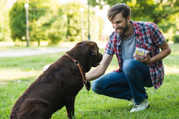 Homme, tenue, nourriture, conteneur, jouer, chien