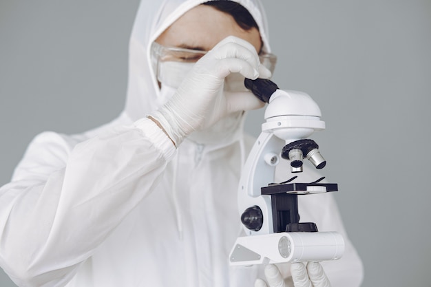 Homme en tenue de protection et lunettes travaillant au laboratoire