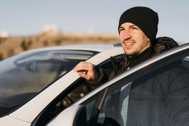 Homme de tir moyen avec voiture