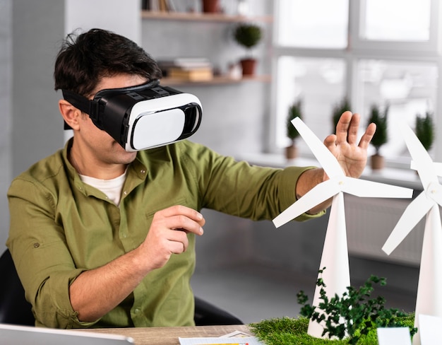 Homme travaillant sur un projet d'énergie éolienne écologique avec casque de réalité virtuelle