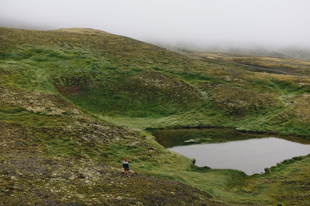 Homme voyageur marche arund islandais paysage