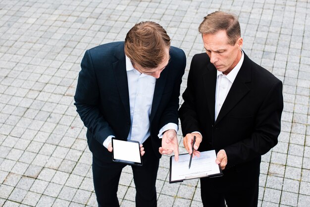 Hommes d'affaires à angle élevé discutant d'informations