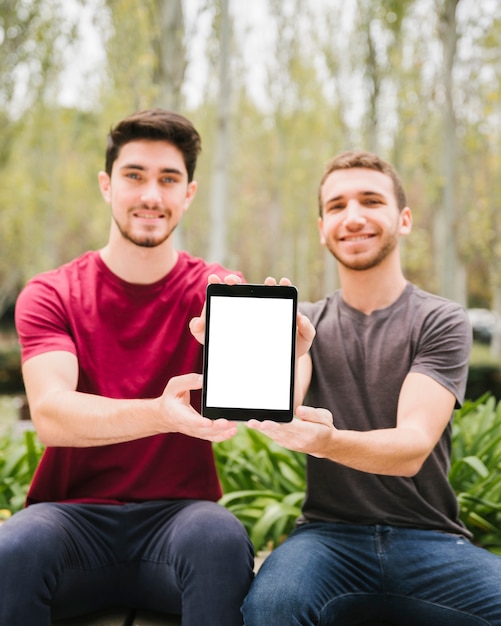 Photo gratuite hommes modernes avec tablette dans la campagne