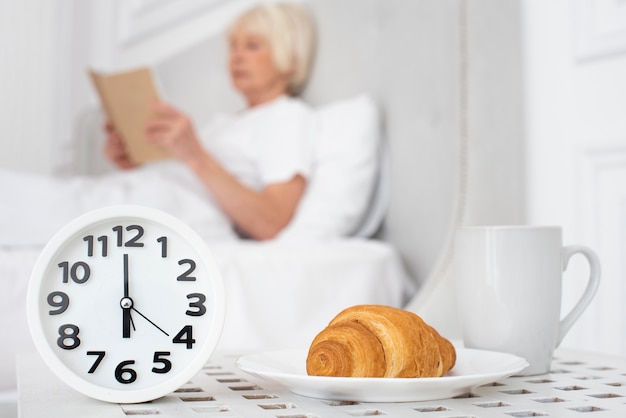 Horloge et un croissant sur fond femme tenant un livre