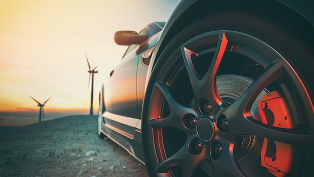 L'image devant la scène de la voiture de sport derrière comme le soleil se couche avec des éoliennes à l'arrière. rendu et illustration 3d.