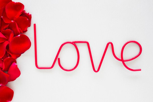 Inscription d&#39;amour avec des pétales de roses sur une table lumineuse