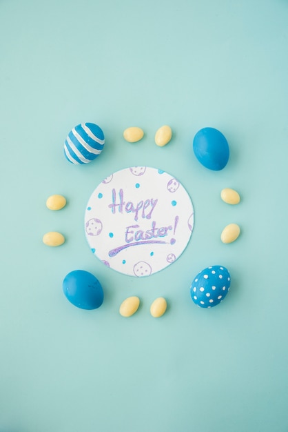 Inscription de Joyeuses Pâques sur papier avec des oeufs colorés