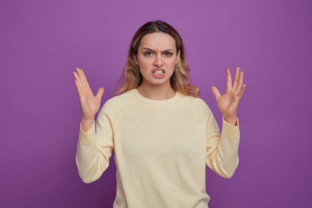 Irritée jeune fille gardant les mains en l'air