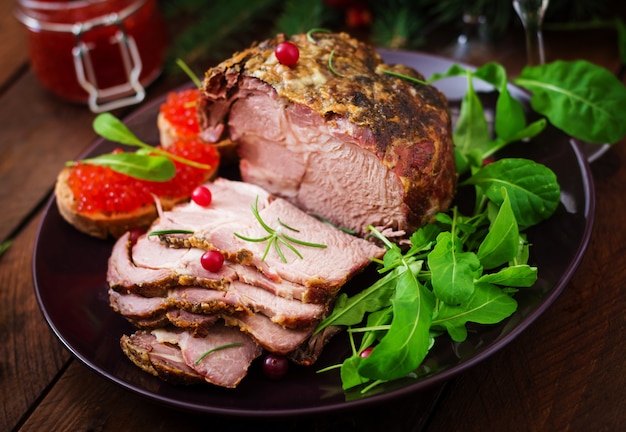 jambon cuit au four et caviar rouge, servi sur une vieille table en bois.