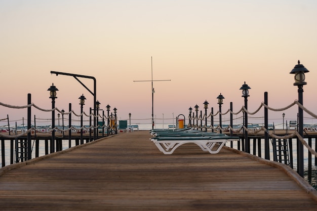 Jetée en bois vide au beau matin calme. Quai touristique dans la baie de la mer