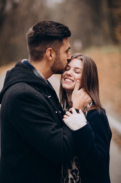 Jeune couple ensemble marchant dans un parc d'automne