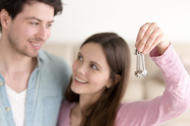 Jeune couple gai tenant les nouvelles clés de la maison