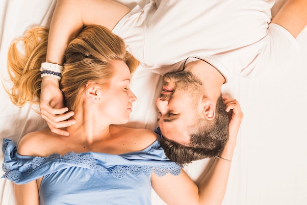 Jeune couple romantique sur le lit