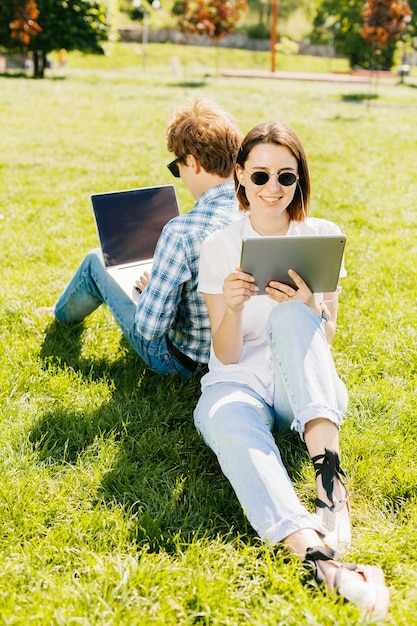 Photo gratuite jeune couple travaillant dans le parc