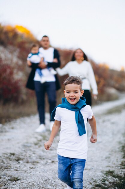 Jeune famille avec deux fils ensemble à l'extérieur du parc