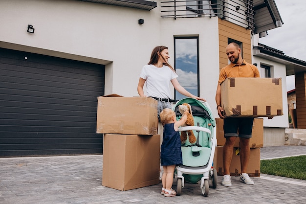 Jeune famille avec petite fille emménageant dans une nouvelle maison