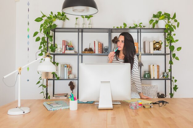 Jeune femme d&#39;affaires penser au bureau