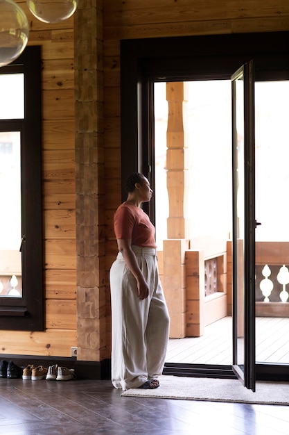 Jeune femme afro-américaine regardant par la fenêtre