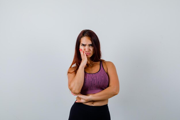 Jeune femme aux cheveux longs portant des vêtements de sport