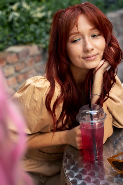 Jeune femme aux cheveux rouges en souriant