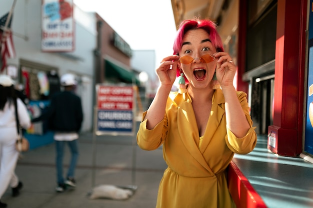 Photo gratuite jeune femme aux cheveux teints près de la boutique