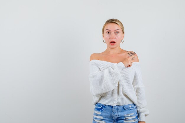 Jeune femme blonde dans un cardigan blanc