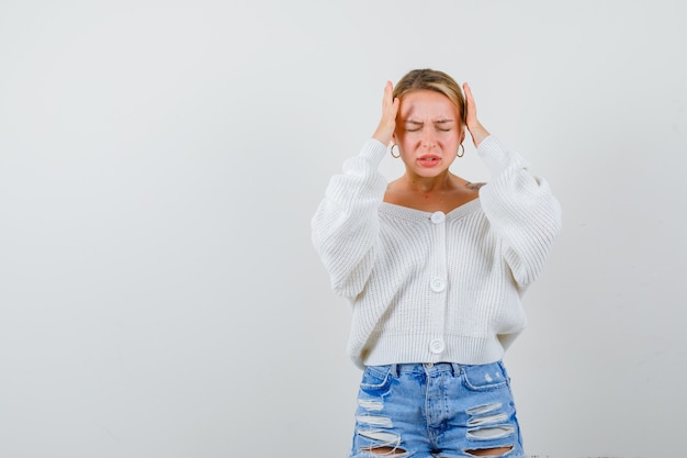 Jeune femme blonde dans un pull blanc