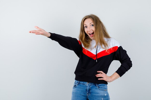 Jeune femme blonde dans une veste et un jean