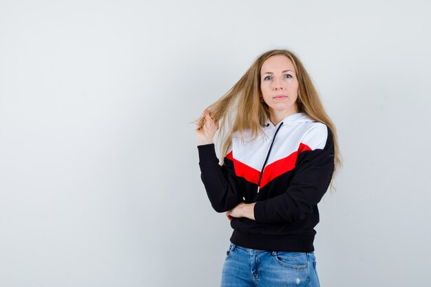 Jeune femme blonde dans une veste et un jean