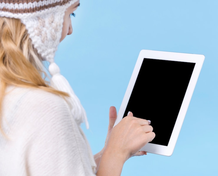Photo gratuit une jeune femme blonde tenant une tablette.