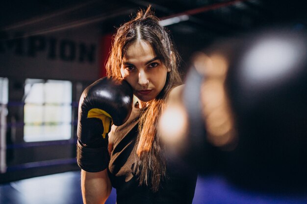 Jeune femme boxeur s'entraînant au gymnase
