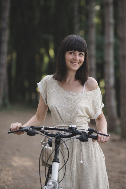 Jeune femme contre nature fond à vélo