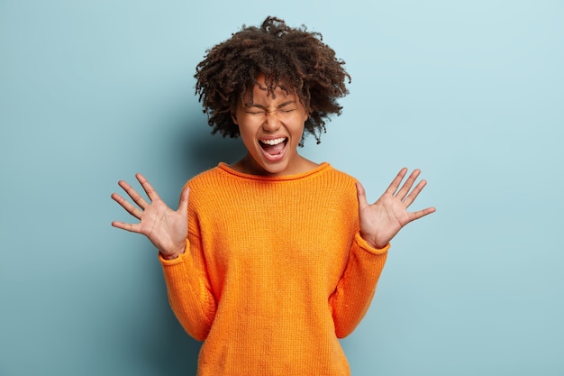 Jeune femme avec coupe de cheveux afro portant un pull