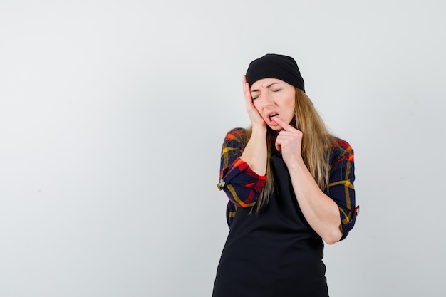 Jeune femme cuisinier dans un tablier noir