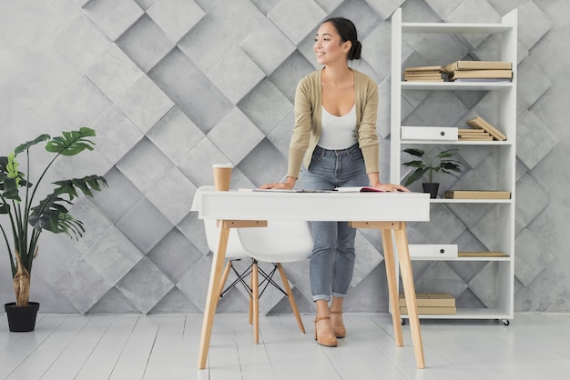 Jeune femme, debout, bureau